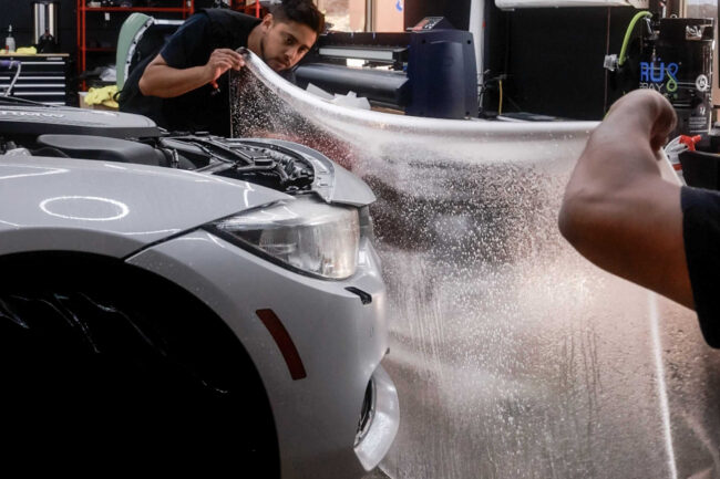 Car with paint protection film applied showing how to prevent scratches and maintain vehicle paint